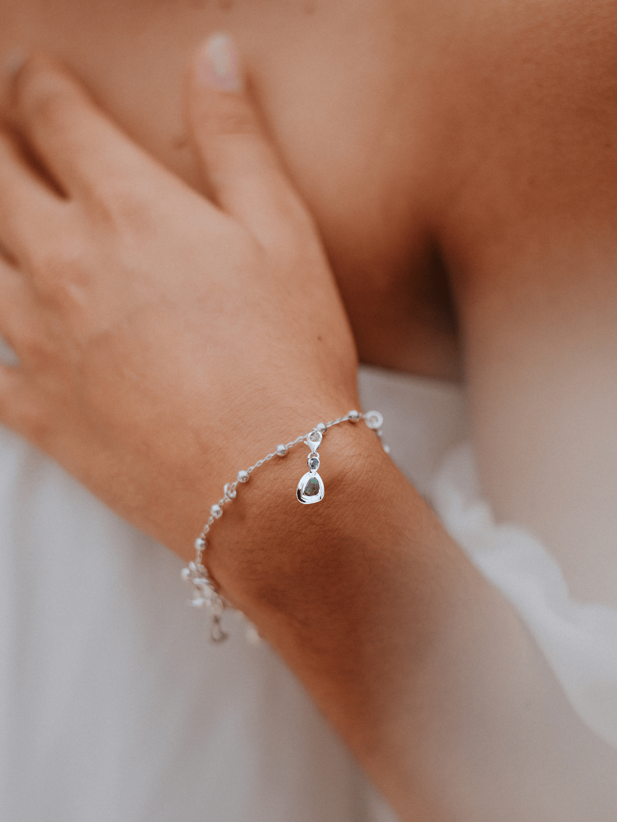 Australian Boulder Opal with Queensland Sapphire Silver Frame Bracelet Charm on model