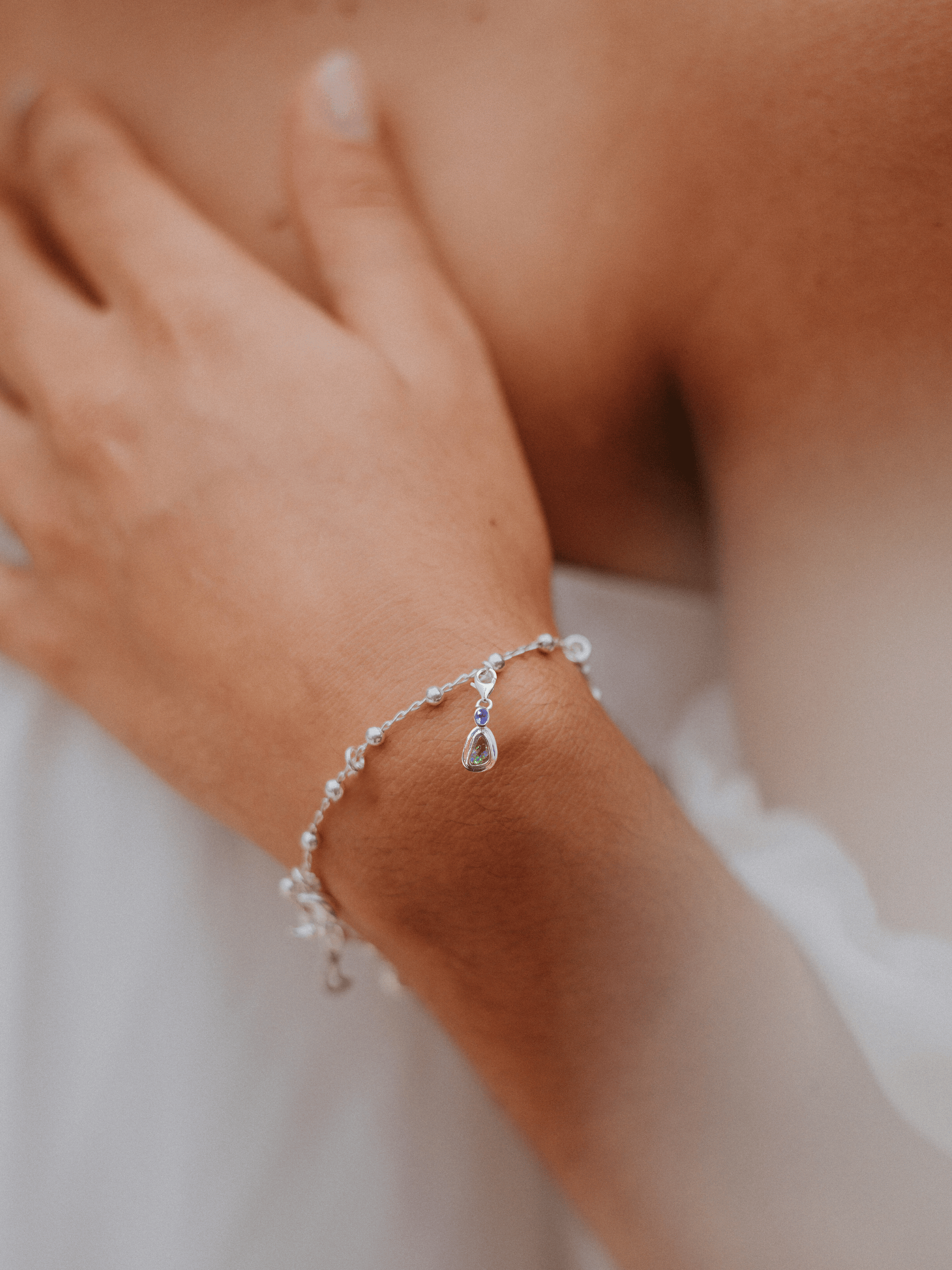 Australian Boulder Opal with Tanzanite Silver Frame Bracelet Charm on model