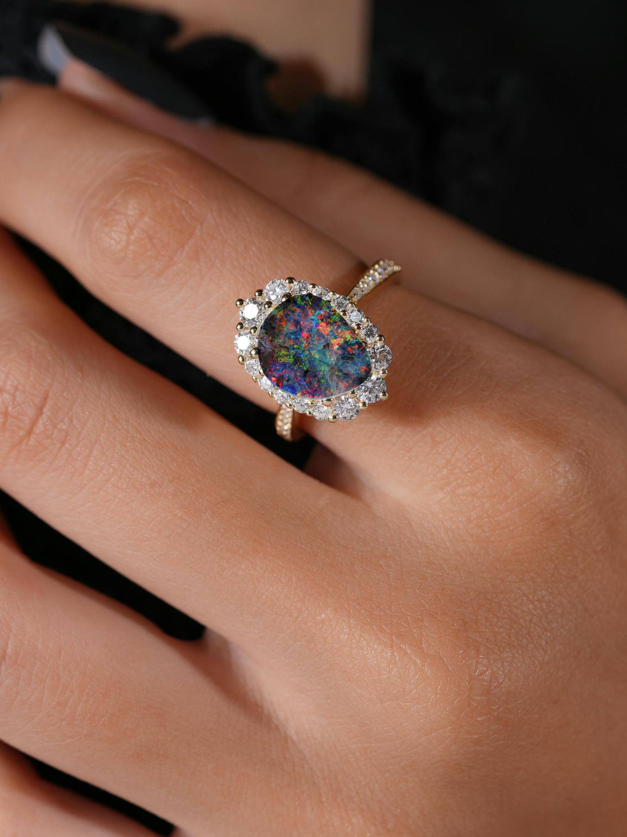 Ring with a colorful opal diamonds on a lady's finger