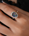Ring with a colorful opal diamonds on a lady's finger